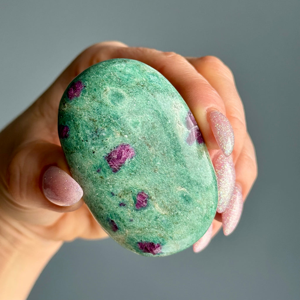 Ruby in Fuchsite palm stone showing red ruby inclusions in green fuchsite