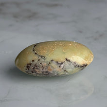 Chrysoprase palm stone held in hand for scale