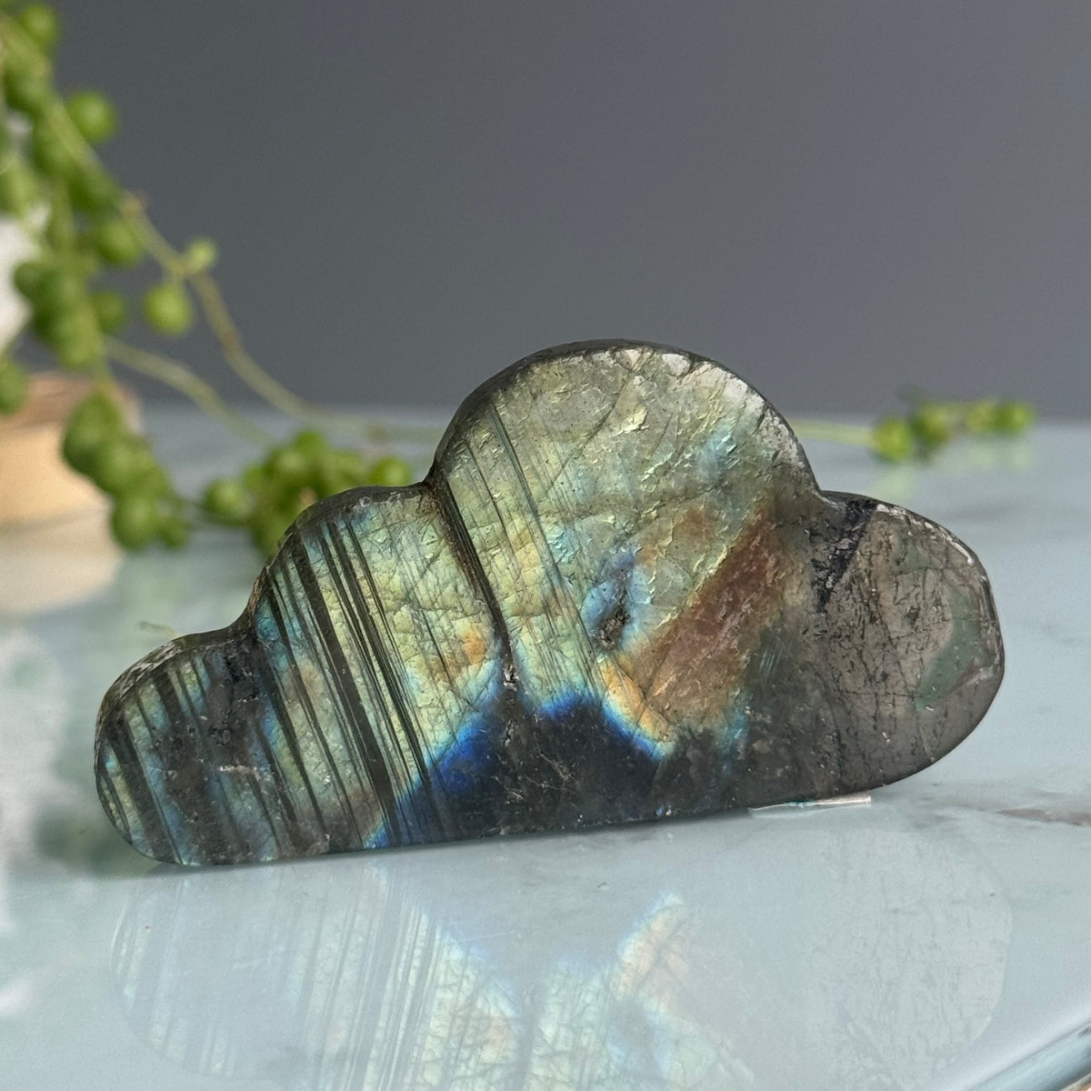 Labradorite carved cloud specimen held in hand for scale
