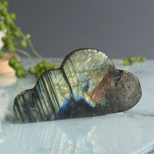 Labradorite carved cloud specimen held in hand for scale