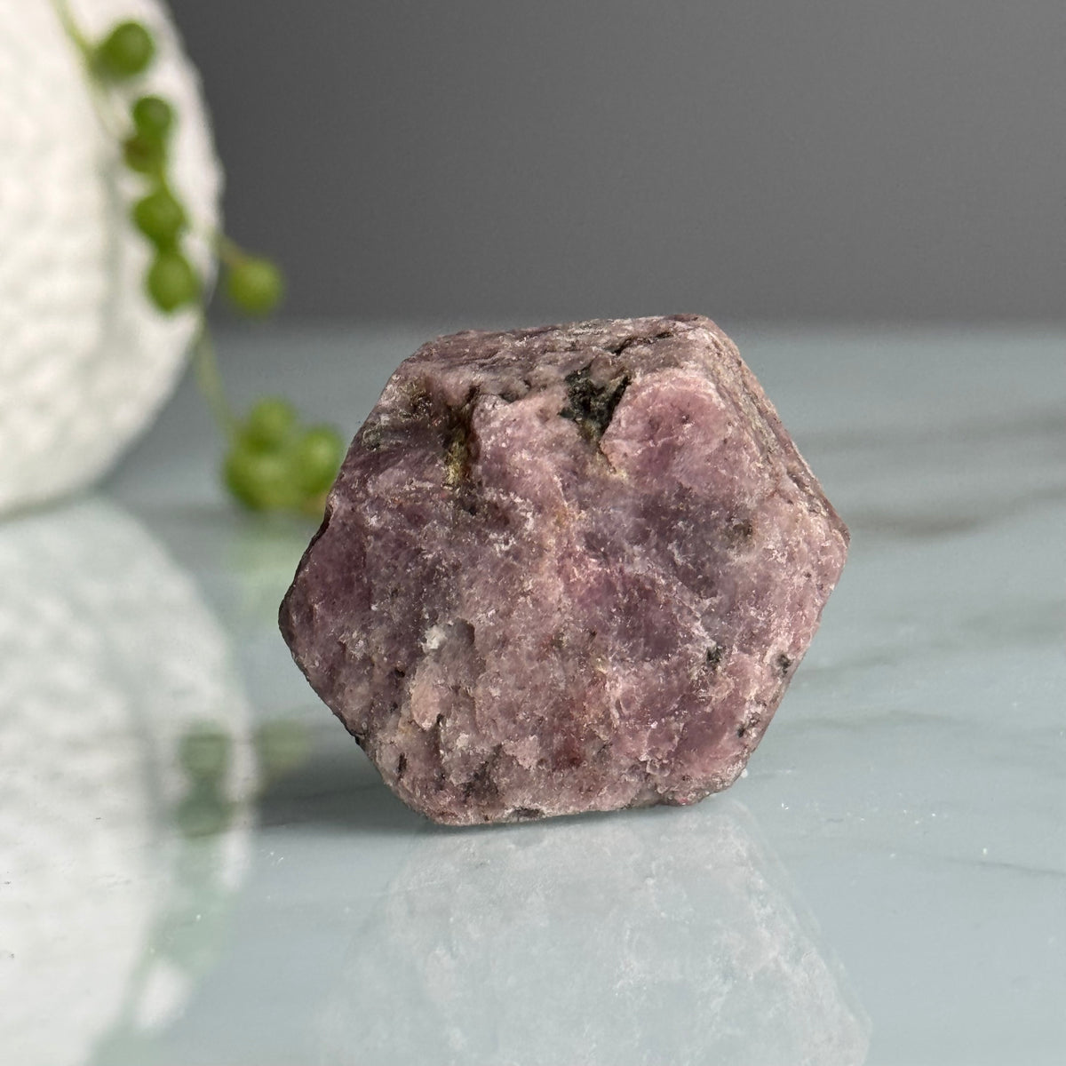 Ruby hexagon crystal specimen held in hand for scale