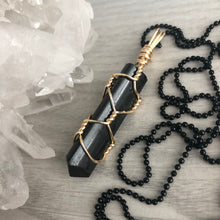 Black tourmaline wrapped in gold wire on a black chain necklace – Wholehearted Crystal Creations