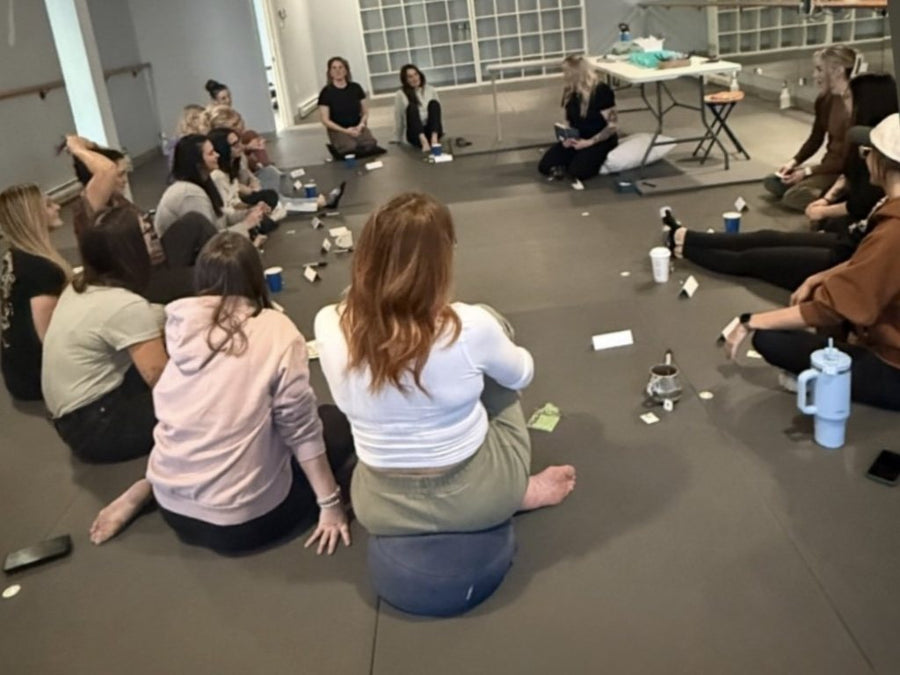Workshop group sitting in a circle on the studio floor