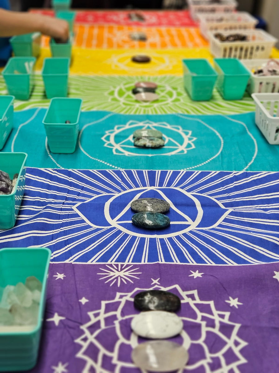 Chakra-coloured crystal stations for a group necklace workshop