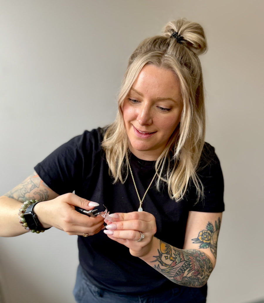 Laurie of Wholehearted Crystal Creations wire wrapping a crystal pendant with pliers